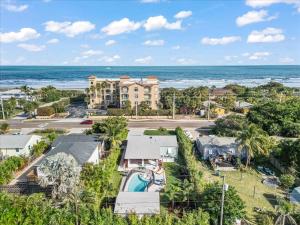 an aerial view of a resort and the ocean at Private Pool, Backyard, and Steps to the Beach in Cocoa Beach