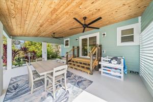 a dining room with a wooden ceiling and a table at Private Pool, Backyard, and Steps to the Beach in Cocoa Beach