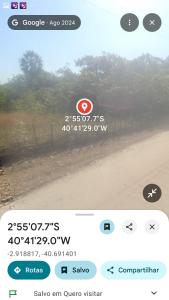 a screenshot of a phone with a view of a field at Camping ao ar livre in Camocim