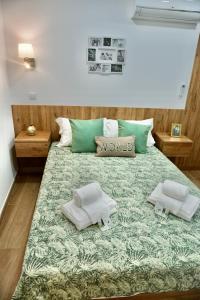 a bedroom with a large bed with towels on it at Casa Tapada do Bento II- Albufeira in Albufeira