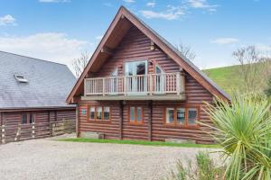 a log cabin with a balcony and a house at 3 Bed in Wadebridge oc-p34722 in Little Petherick