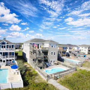 an aerial view of a apartment complex with a pool at Serenity in Nags Head - MP 11, Oceanfront, Ocean View, Pool, Hot Tub, Pets OK, YR Flex Stays in Nags Head