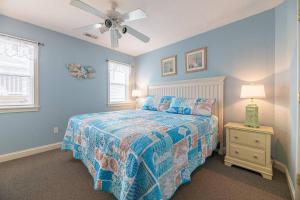 a bedroom with a bed and a ceiling fan at Serenity in Nags Head - MP 11, Oceanfront, Ocean View, Pool, Hot Tub, Pets OK, YR Flex Stays in Nags Head +45 photos