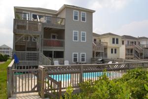 a house with a deck and a swimming pool at Serenity in Nags Head - MP 11, Oceanfront, Ocean View, Pool, Hot Tub, Pets OK, YR Flex Stays in Nags Head