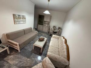 a living room with a couch and a table at KATERINA's House in Preveza