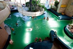 a group of people swimming in a swimming pool at Aurora Premium Home in Győr