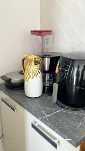 a counter top with a blender and a coffee maker at Casa praia 99 in Serra