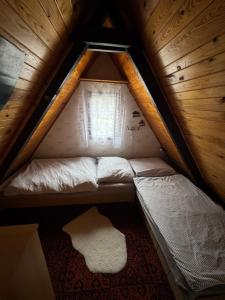 a small room with two beds in a attic at chata u Ondrucha in Tři Studně