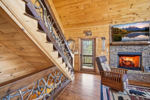 a staircase in a log home with a fireplace at Majestic Mountaintop Escape in Blue Ridge