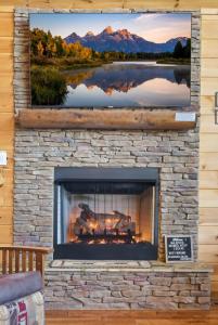 a fireplace in a living room with a picture of a lake at Majestic Mountaintop Escape in Blue Ridge +41 photos