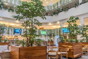 a lobby with potted plants and tables and chairs at Friendly Fun Vallarta Different Experiences - All Inclusive in Puerto Vallarta