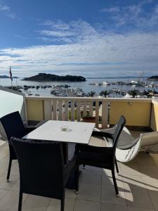 a table and chairs on a balcony with a marina at Villa Ljubica in Pakoštane