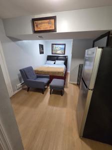 a small bedroom with a bed and a refrigerator at Executive private room in Irvington