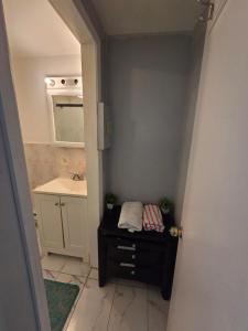 a small bathroom with a sink and a mirror at Executive private room in Irvington