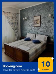 a bedroom with a large bed with blue walls at Marsali Vila in Constanţa