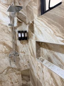 a shower in a bathroom with a stone wall at PF Hotel in San Felipe de Puerto Plata +43 photos