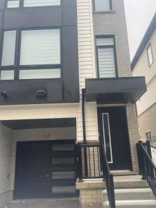 a house with a black front door and stairs at Modern 3BR FriendlyTown Home in Paris