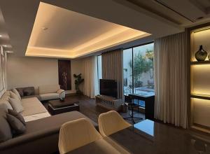 a living room with a couch and a television at Ramla Resort in Riyadh