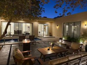 a patio with a wooden table and chairs at Ramla Resort in Riyadh