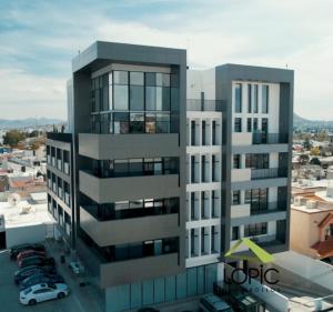 a tall building with a parking lot in front of it at Penthouse Panoramic Terrace, San Felipe in Chihuahua +7 photos
