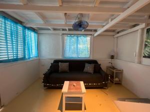 a living room with a couch and a table at Hostel La Bohème in Las Terrenas