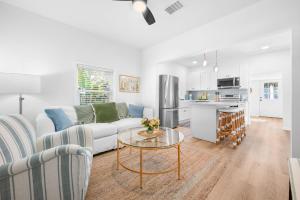 a living room with a couch and a table at Casa Madeore Luxury Bungalow in St. Augustine