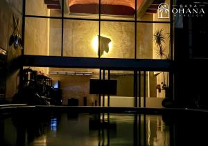 a building with a swimming pool in front of it at Casa Ohana Morelos in Tlayacapan