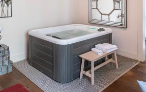 a bath tub with a wooden stool in a bathroom at Relais La Lanterne in Cagliari +71 photos