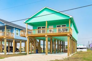 a house with a deck on top of it at Minutes to Beach & Jetty Fishing Fun Get-a-way in Surfside Beach