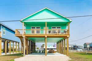 a green house with a deck on top of it at Minutes to Beach & Jetty Fishing Fun Get-a-way in Surfside Beach +18 photos