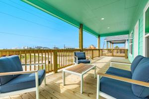 a porch with two blue chairs and a table at Minutes to Beach & Jetty Fishing Fun Get-a-way in Surfside Beach