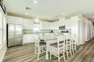 a kitchen with white cabinets and a table and chairs at Minutes to Beach & Jetty Fishing Fun Get-a-way in Surfside Beach