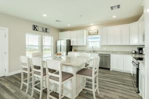a kitchen with white cabinets and a table and chairs at Minutes to Beach & Jetty Fishing Fun Get-a-way in Surfside Beach