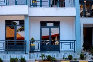 an apartment building with blue doors and balconies at Global Village Apartment in Kigali
