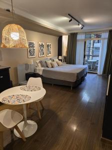 a bedroom with a bed and a table and chairs at Studio FR Palermo Hollywood in Buenos Aires
