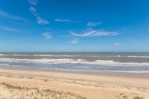 a sandy beach with the ocean in the background at Jacks - Nags Head MP 12, Oceanfront, Ocean Views, Huge Deck, YMCA Pkg in Nags Head
