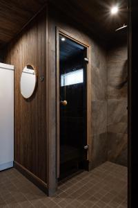 a bathroom with a shower with a glass door at Villa Light in Ruka +29 photos