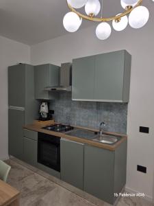 a kitchen with a sink and a stove at B&B Domus morfeo Caserta in Caserta