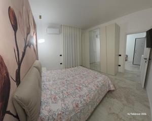 a bedroom with a bed with a floral bedspread at B&B Domus morfeo Caserta in Caserta +21 photos