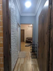 a hallway with blue walls and a brick wall at warm house in Tsqaltubo