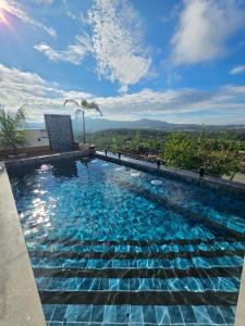 a swimming pool on top of a building at Mirante Vista Nobre in Maricá