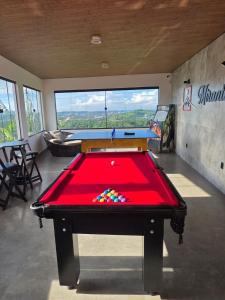 a red pool table in a room with a view at Mirante Vista Nobre in Maricá