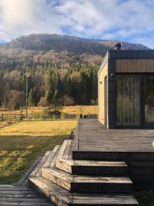 a house on a wooden ramp with a hill in the background at Paporoti House in Korostov +11 photos