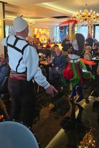 two people dressed in costumes standing in a restaurant at Hotel Diamant in Tropojë