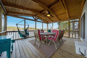 a patio with a table and chairs on a deck at Deep Water Stays on Lake Murray in Lake Murray Shores