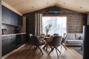 a kitchen and dining room with a table and chairs at Villa Light in Ruka