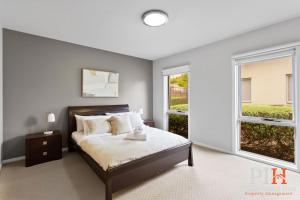 a bedroom with a bed and a large window at Townhouse with Shared Pool in Cowes in Cowes