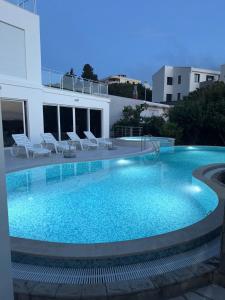 a large swimming pool next to a building at Sea Whisper Villa in Dobra Voda
