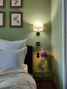a bedroom with a bed and a table with flowers on it at BellevueBretagne - Chambres d'Hôtes in Saint-Jean-du-Doigt +4 photos