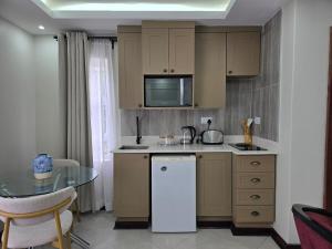 a kitchen with a table and a counter top at Charming Studio in Golden Triangle in Harare